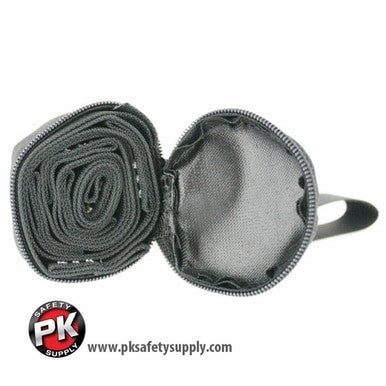 A coiled black DBI-SALA Suspension Trauma Strap 9501403, created by 3M Fall Protection to prevent suspension trauma, is partially unzipped from a round, black case. The PK Safety logo is visible on the bottom left corner, with the URL "www.pksafetysupply.com" displayed below.