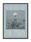 "Under the Paris Sky" is a minimalist blue and pink typography collage poster by Opposite Wall of a deconstructed vintage photography of a man with a pink rose on his head and the words ‘under the paris sky’ in French.